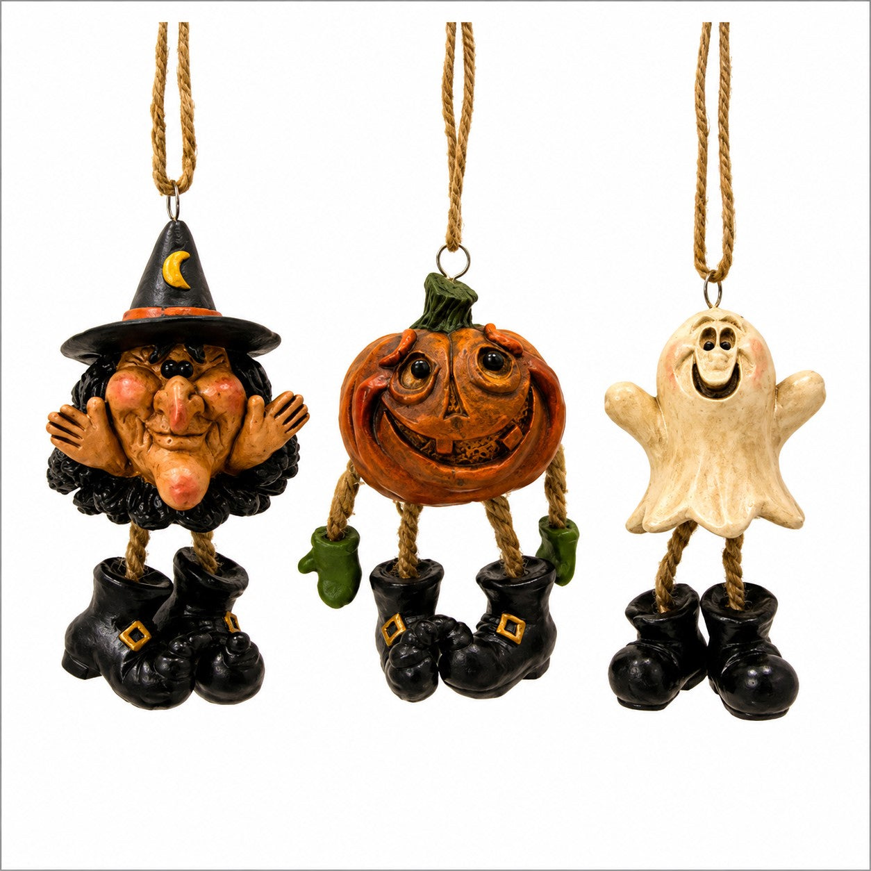 Three Halloween hanging ornaments on a white background: a witch figure in a black hat and boots, a carved pumpkin face with green mittens, and a cream ghost figure in a white sheet and black boots.