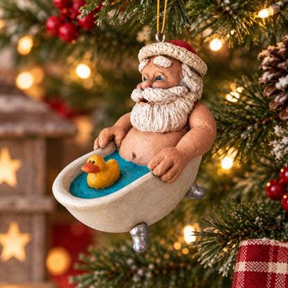 Bert Anderson Santa in a bathtub ornament with yellow rubber duck hanging on a Christmas tree with festive lights and greenery.