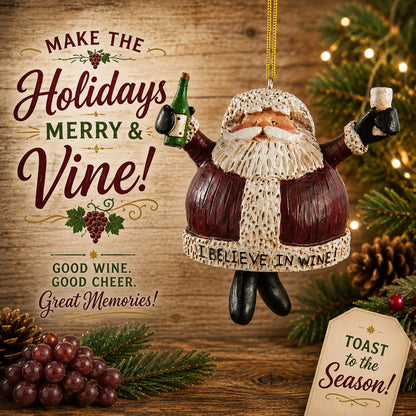 Bert Anderson “I Believe in Wine” Santa ornament holding a wine bottle and glass in a festive Christmas setting with greenery and grapes.