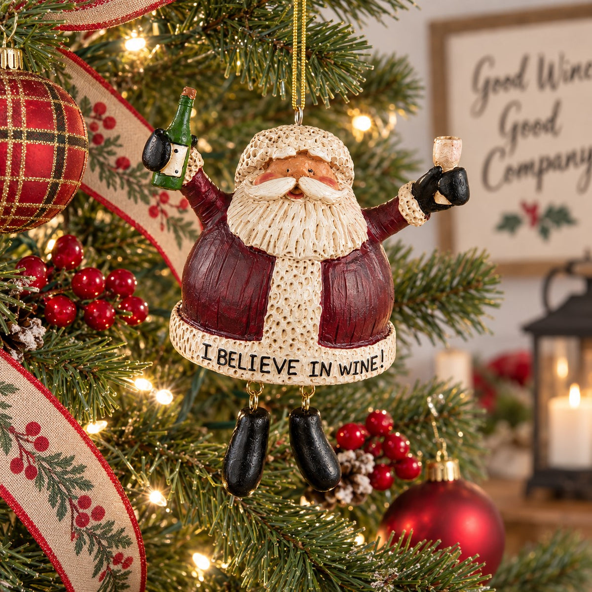 Bert Anderson “I Believe in Wine” Santa ornament holding a wine bottle and glass hanging on a brightly lit Christmas tree.