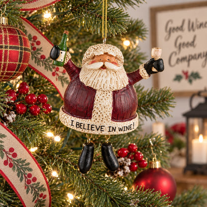 Bert Anderson “I Believe in Wine” Santa ornament holding a wine bottle and glass hanging on a brightly lit Christmas tree.