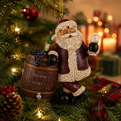 darker setting: Bert Anderson Santa wine ornament carrying a wine barrel, bottle and glass displayed among Christmas tree lights and holiday décor.