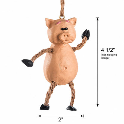 A hanging pig decoration with a tan body, rope arms and legs, black hooves, and a black nose, shown on a white background with dimension labels indicating 4 1/2 inches height and 2 inches width.