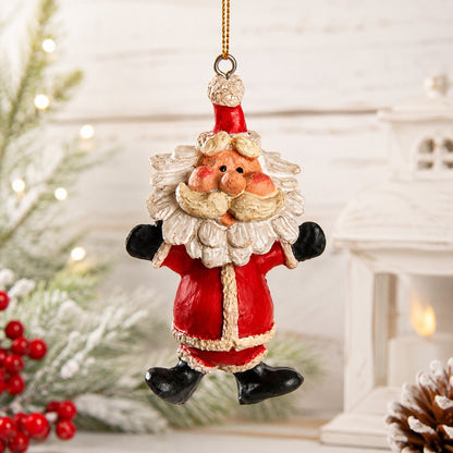 A festive Santa Claus bobble head hanging ornament with a red suit, white beard, and black boots, suspended by a gold string against a softly blurred holiday background with lights and greenery.