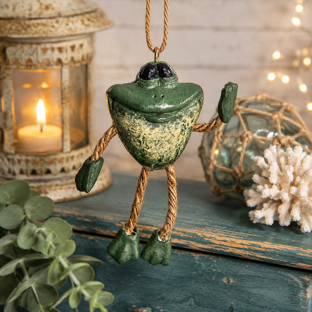 A green frog hanging ornament with rope limbs and feet.  Bert Anderson collectible.