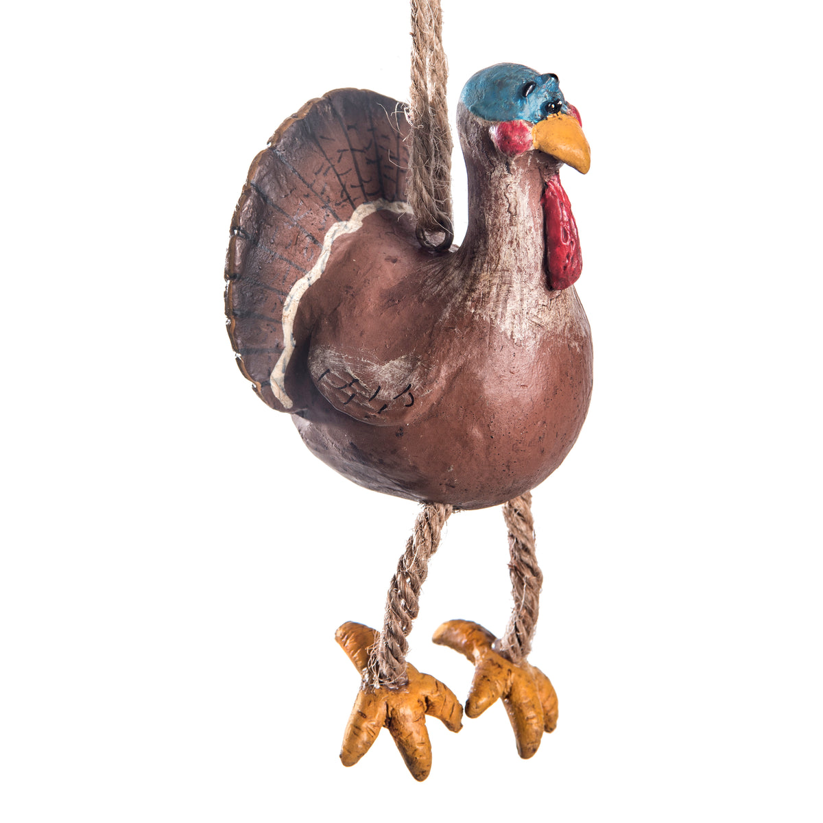 A rustic hanging turkey ornament with a brown textured body, blue head, red wattle, yellow beak, and rope legs against a white background.