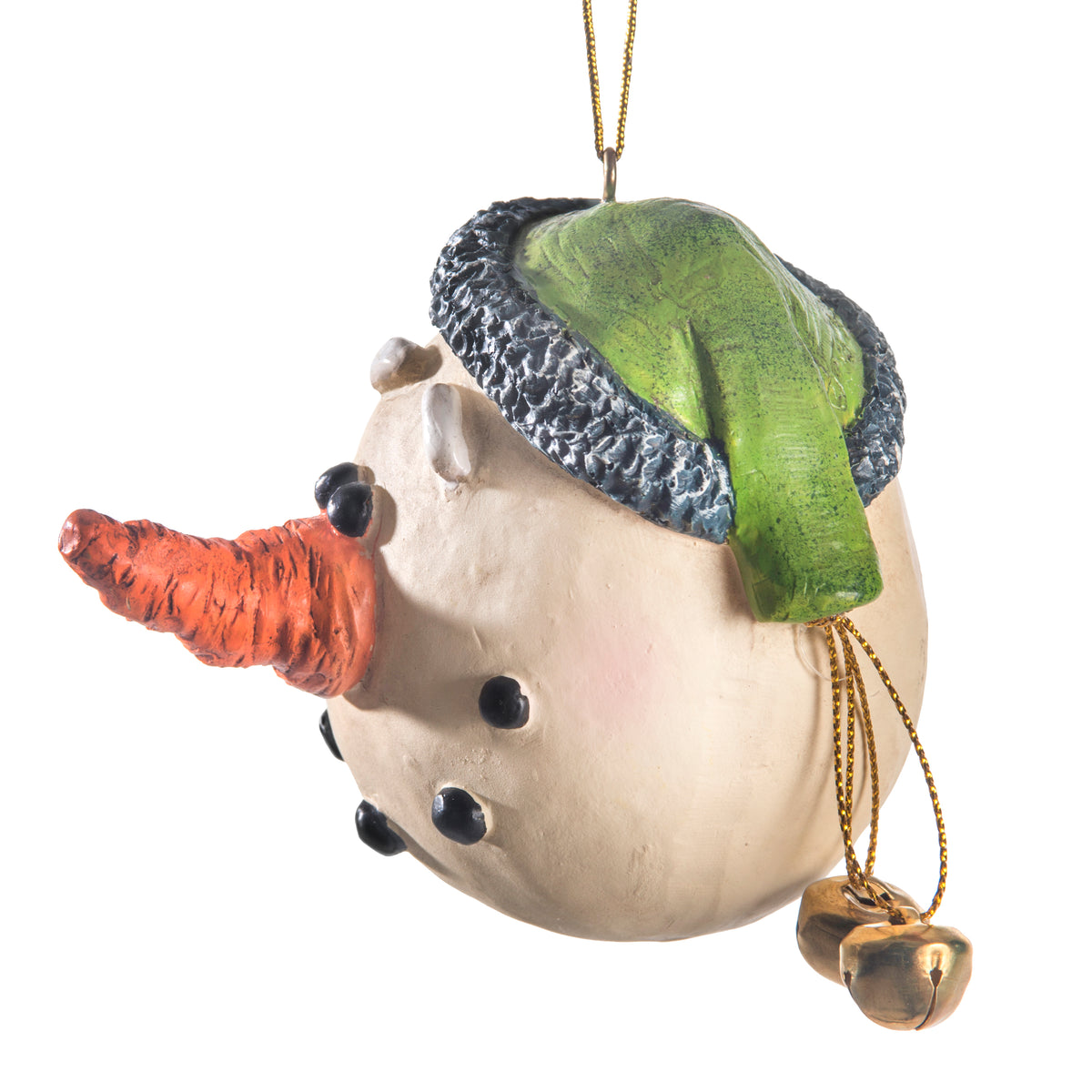 Side view of a snowman ornament with a textured cream face, a bright orange carrot nose, a green hat with a dark gray brim, and small gold bells hanging from a gold hanging string.