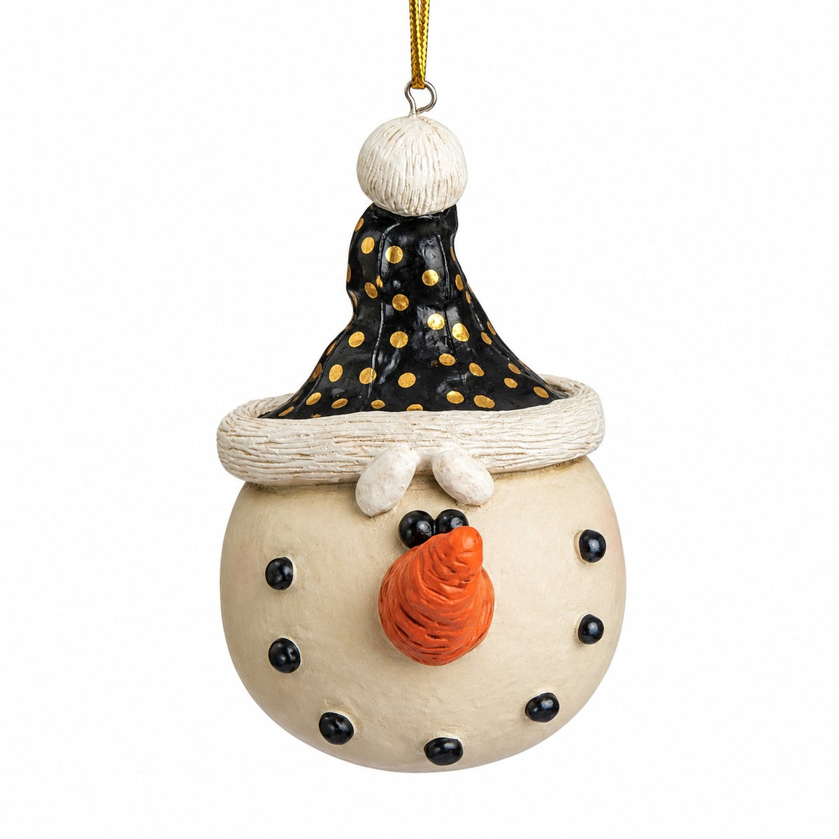 A resin snowman Christmas ornament with a cream-colored body, black and gold polka-dot hat, white buttons, and an orange nose, hanging by a gold string against a white background.