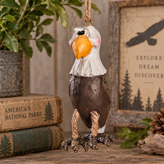 Bert Anderson bald eagle ornament with dangling rope legs displayed in rustic national park-inspired home décor.
