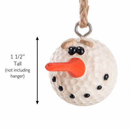 A snowman ornament resembling  a white golf ball with a bright orange carrot nose, black dot eyes and hands, and a brown twig-style hat, hanging from a rope hanger. A vertical measurement arrow on the left indicates the height is 1 1/2 inches tall (not including the hanger).