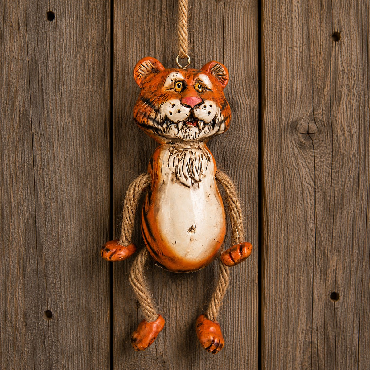 Hand painted tiger ornament by Bert Anderosn.   Displayed on a rustic board background.