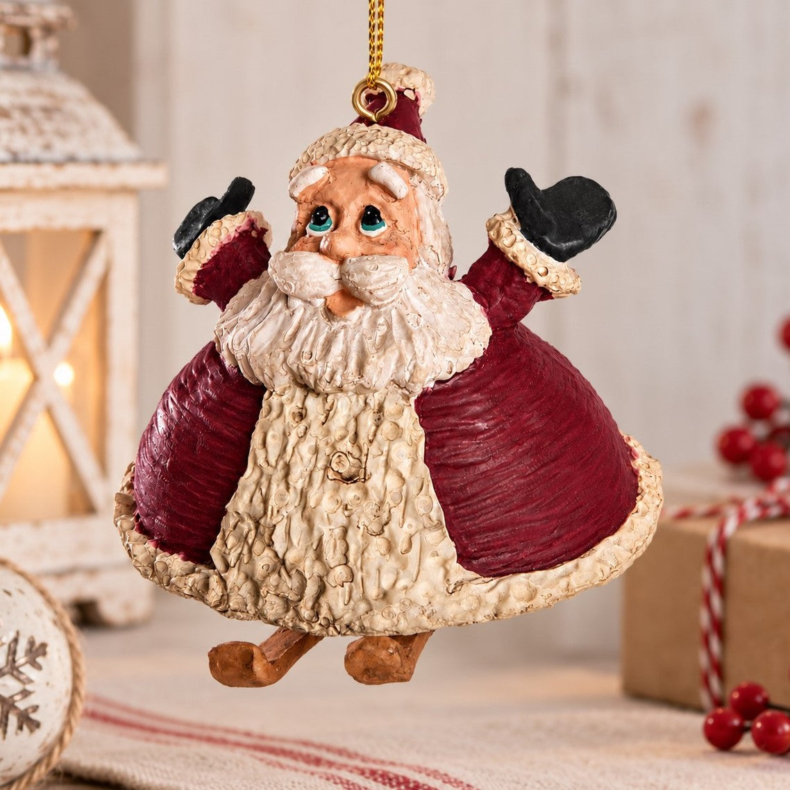 A festive hanging Santa Christmas ornament.  Santa has a pair of dangling  skis.