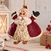 A festive hanging Santa Christmas ornament.  Santa has a pair of dangling  skis.