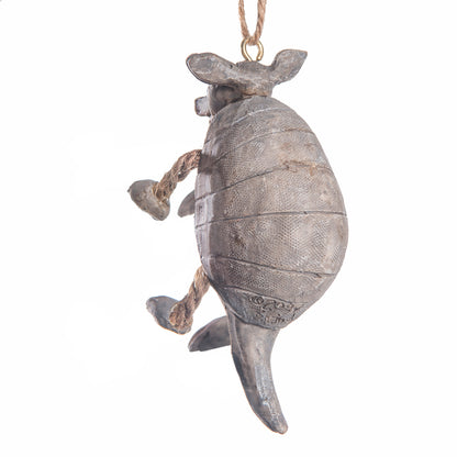 Back view of a rustic gray armadillo hanging ornament with a textured shell, rope legs, and a hanging loop at the top, shown against a plain white background.