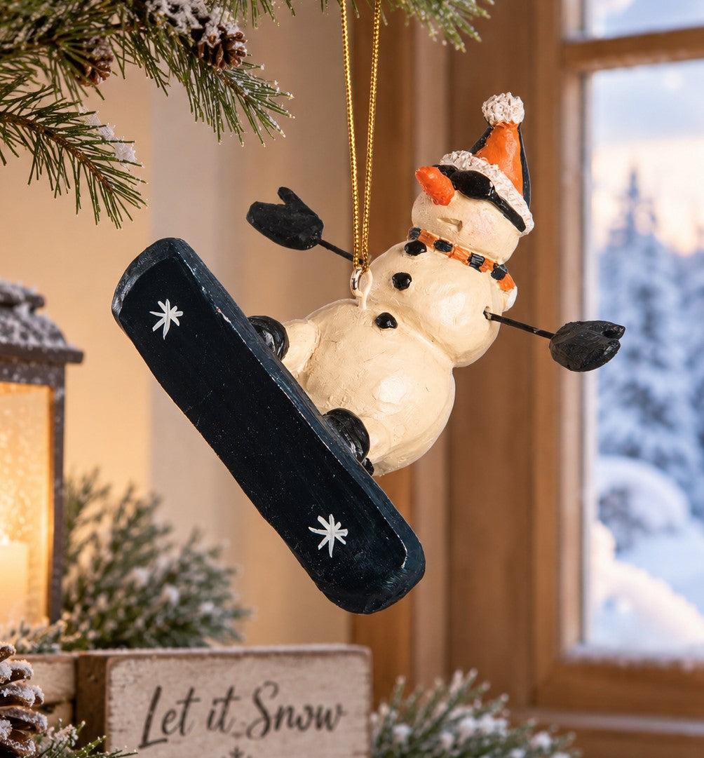 Bert Anderson snowboarding snowman ornament displayed by a winter window with snowy trees and cozy holiday décor.
