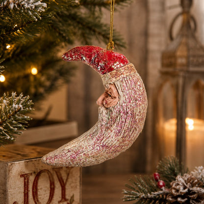 Hand painted resin ornament.  Crescent Moon Santa Ornament with sparkles that shimmer.   Displayed hanging from a Christmas tree.