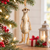 Bert Anderson meerkat ornament with dangling rope arms and legs displayed in bright Christmas home décor with warm lights, red berries and holiday accents.