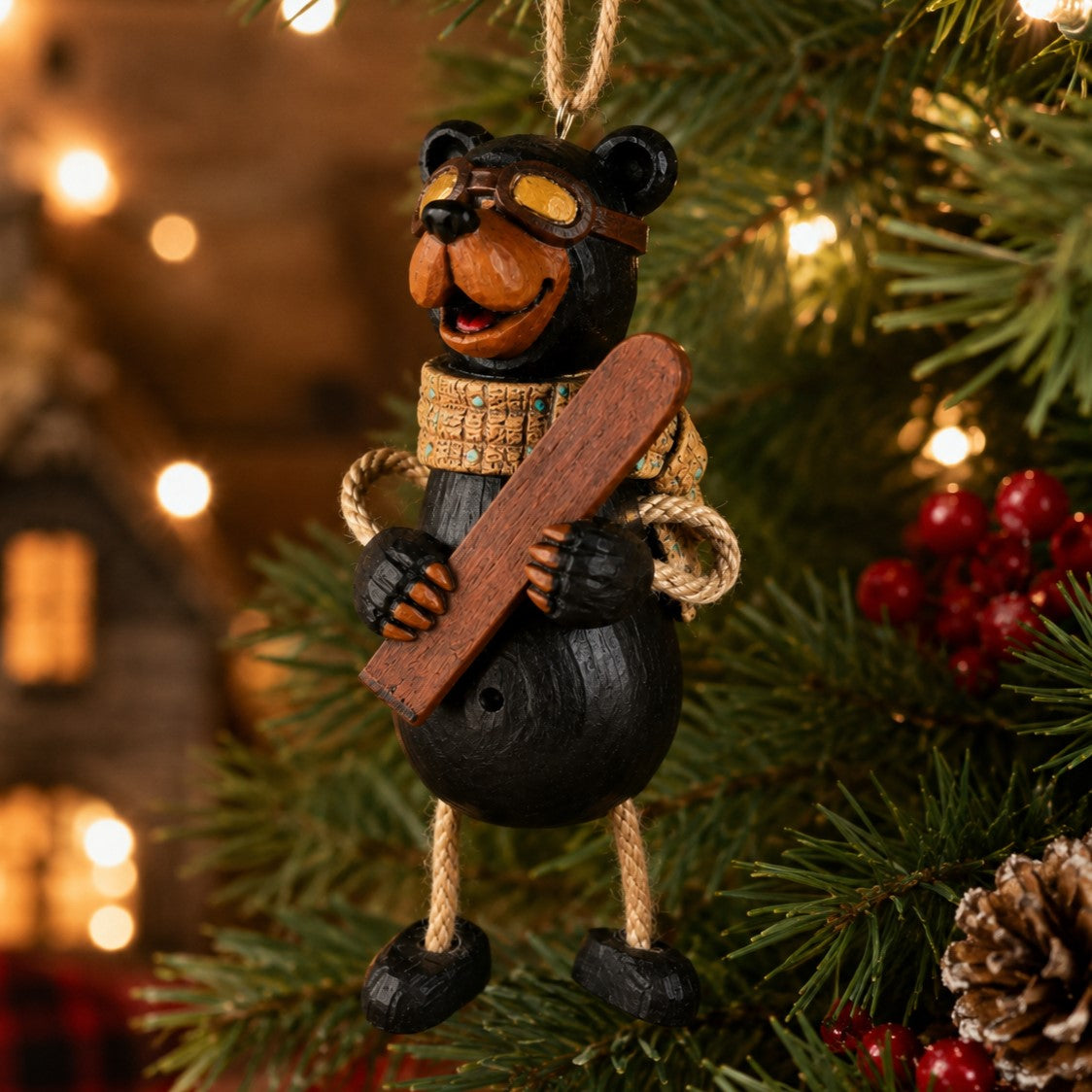 Black Bear Ornament with skis and googles hanging on a Christmas tree.