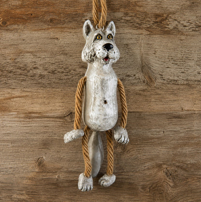 A rustic decorative hanging wolf ornament with jute arms and legs. By artist Bert Anderson