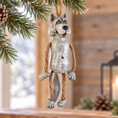 Bert Anderson wolf ornament with dangling rope arms and legs displayed in a bright rustic cabin setting with snowy window and simple winter greenery.