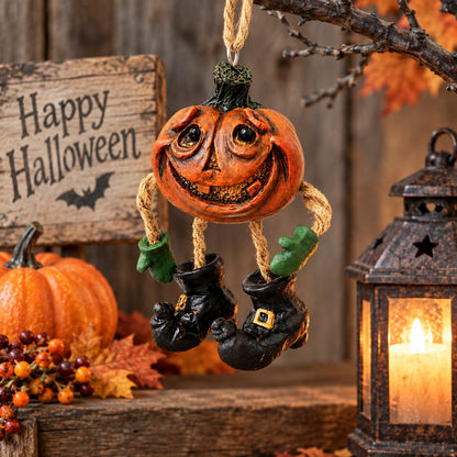 Bert Anderson pumpkin ornament with dangling black boots displayed in rustic Halloween décor with pumpkins, autumn leaves, lantern and wood accents.