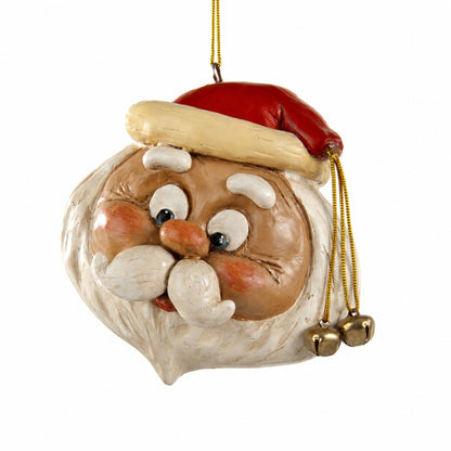 A hand-painted Santa Claus' head  Christmas ornament featuring a red hat with a beige trim, a brown face, white beard, and gold hanging cord with small bells.