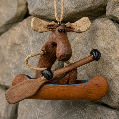 Moose in a canoe ornament displayed on rock wall