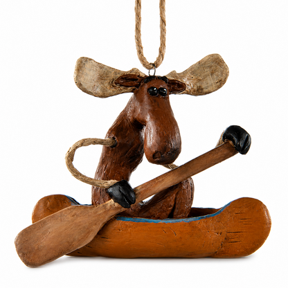 Whimsical moose in a canoe ornament on a white backgroun.  