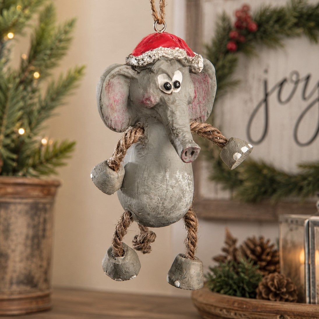 Elephant ornament with a santa hat by Bert Anderson.  Displayed in a Christmas home decor setting.