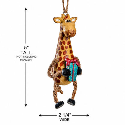 A giraffe hanging ornament with brown spots, rope legs, and a colorful gift box, shown with dimension arrows and text indicating 5 inches tall and 2 1/4 inches wide on a white background.