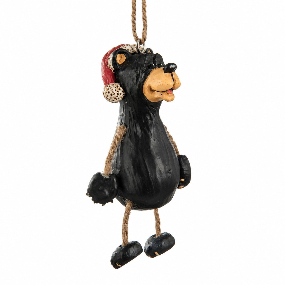 A black bear hanging Christmas ornament with a red Santa hat with dangly rope arms and legs.  White background