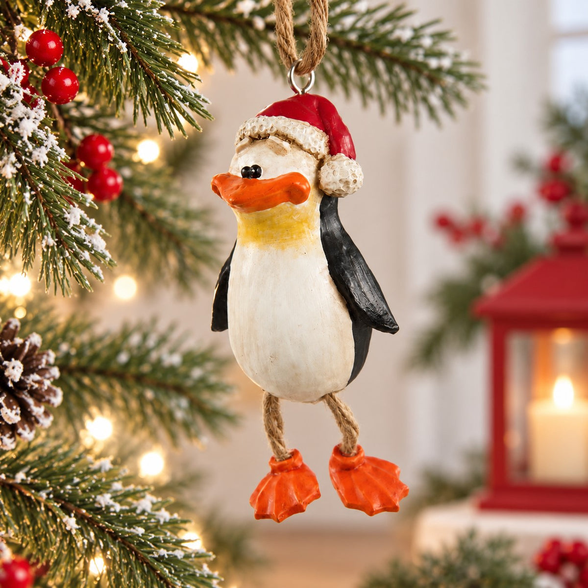 Bert Anderson penguin Christmas ornament with a red Santa hat, and dangly rope legs. A fun holiday decoration or penguin gift.