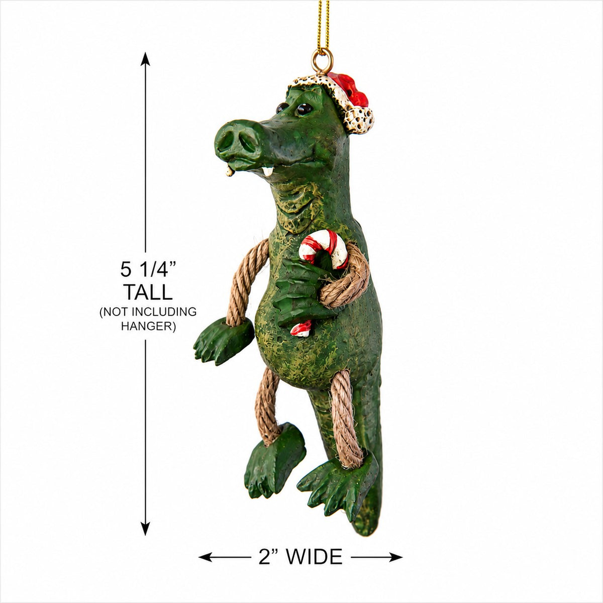 A green alligator Christmas ornament with a Santa hat, dangly arms and legs, and candy cane, shown with dimension arrows indicating 5 1/4 inches tall and 2 inches wide.