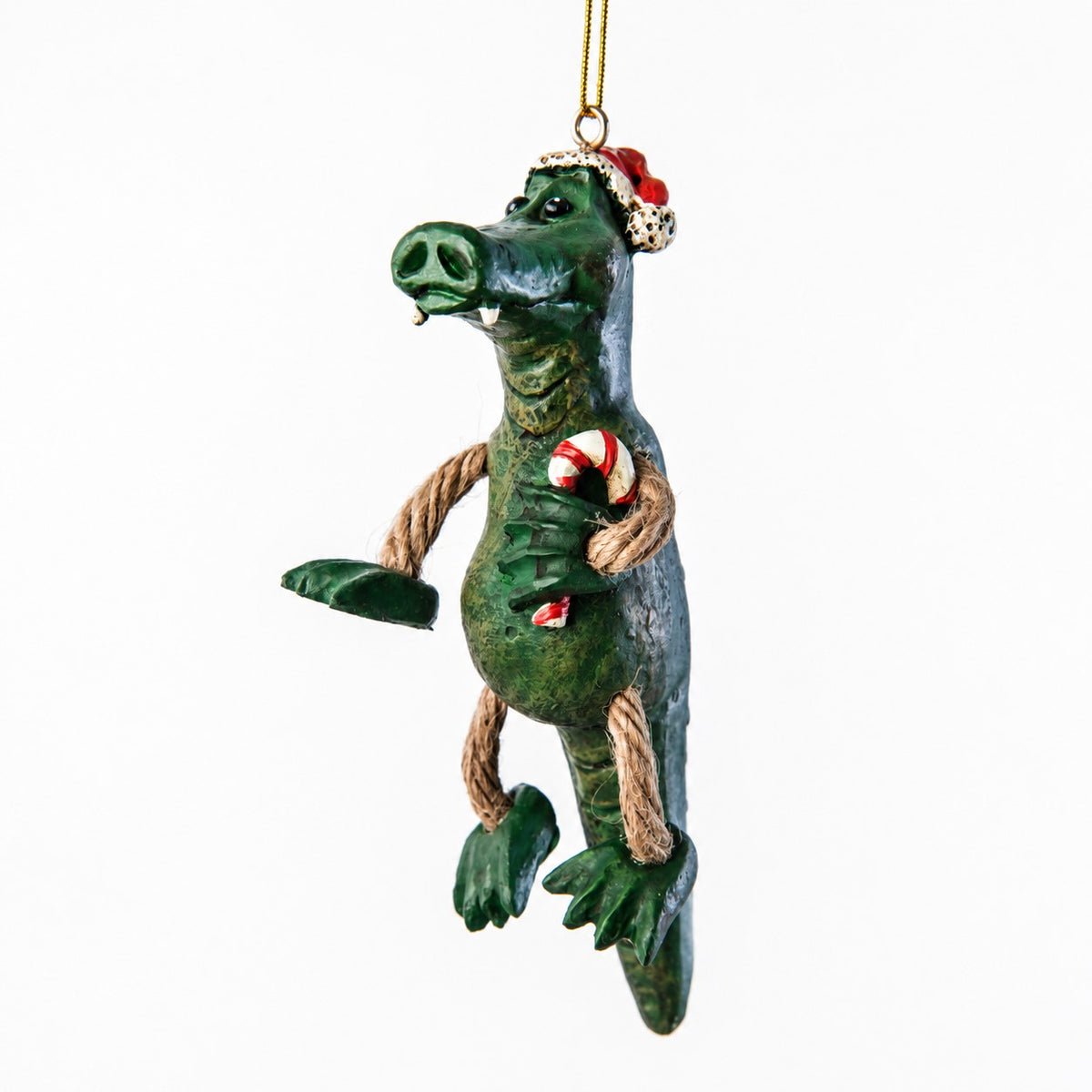 Bert Anderson alligator Christmas ornament holding a cancy cane and wearing a Santa hat.  Show on a white background.