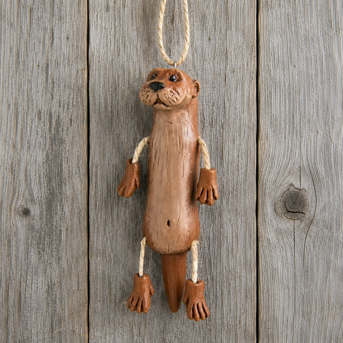River otter ornament on wood plank board.  Designed by Bert Anderson.