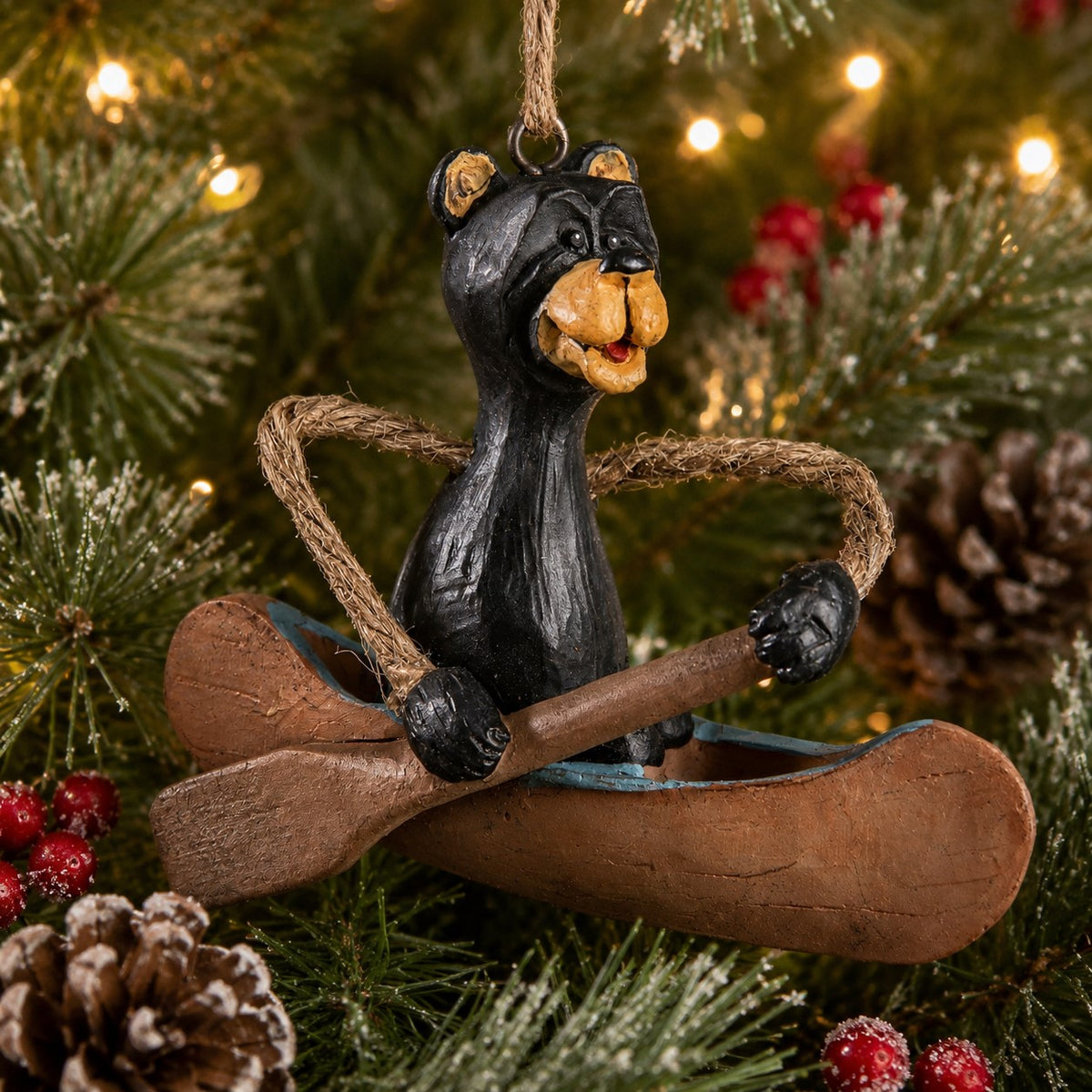 Rustic hanging Bear in  Canoe ornament  displayed on a Christmas tree.