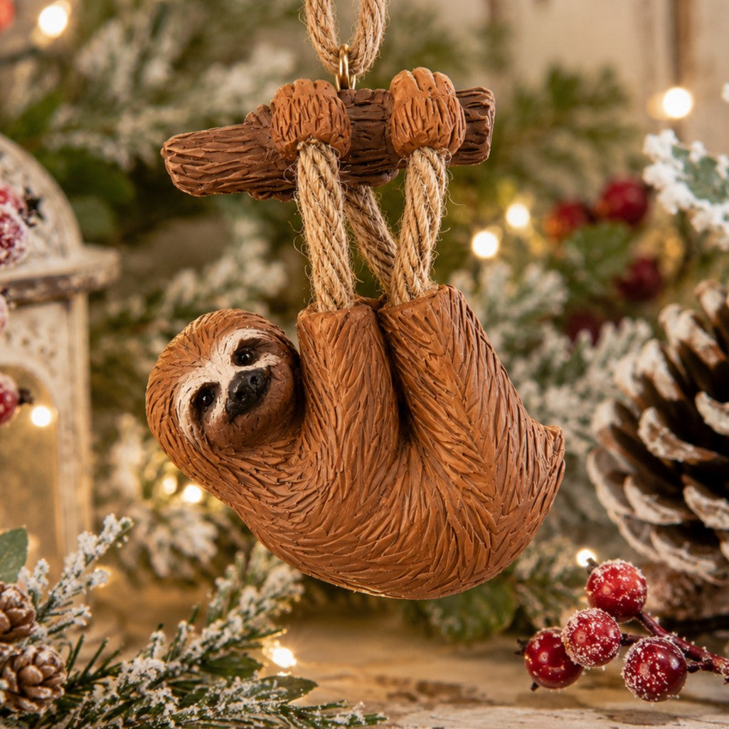 Sloth hanging ornament displayed on a festive Christmas background.  Gift for sloth lovers.