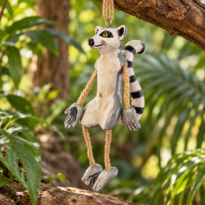 Bert Anderson ring-tailed lemur ornament with dangly rope arms and legs hanging in a lush tropical habitat