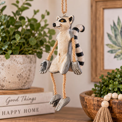 Bert Anderson ring-tailed lemur ornament with striped tail and dangly rope limbs hanging in a warm, natural home décor setting.