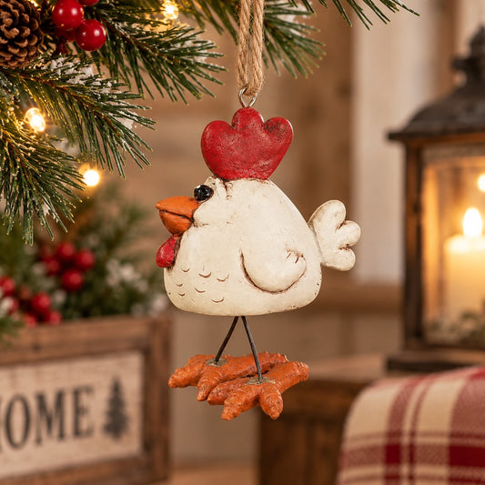 Bert Anderson white chicken ornament with wire legs hanging in a cozy farmhouse holiday setting with warm lights and greenery.