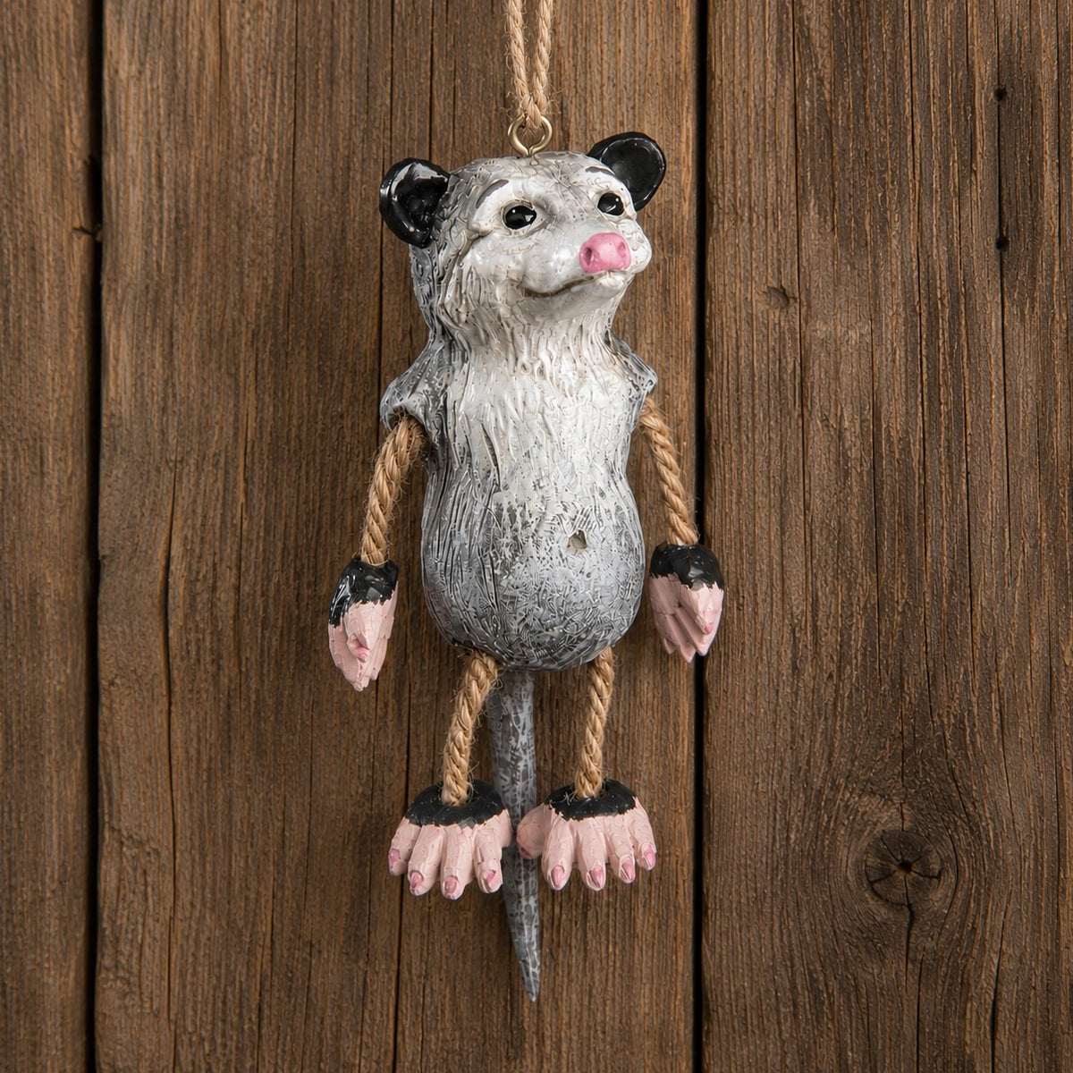 Bert Andereson possum (opossum) ornament on a rustic board background.