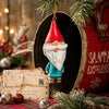 Bert Anderson gnome ornament with red pointed hat, white beard and blue coat displayed in a nostalgic Christmas setting with greenery and vintage holiday décor.