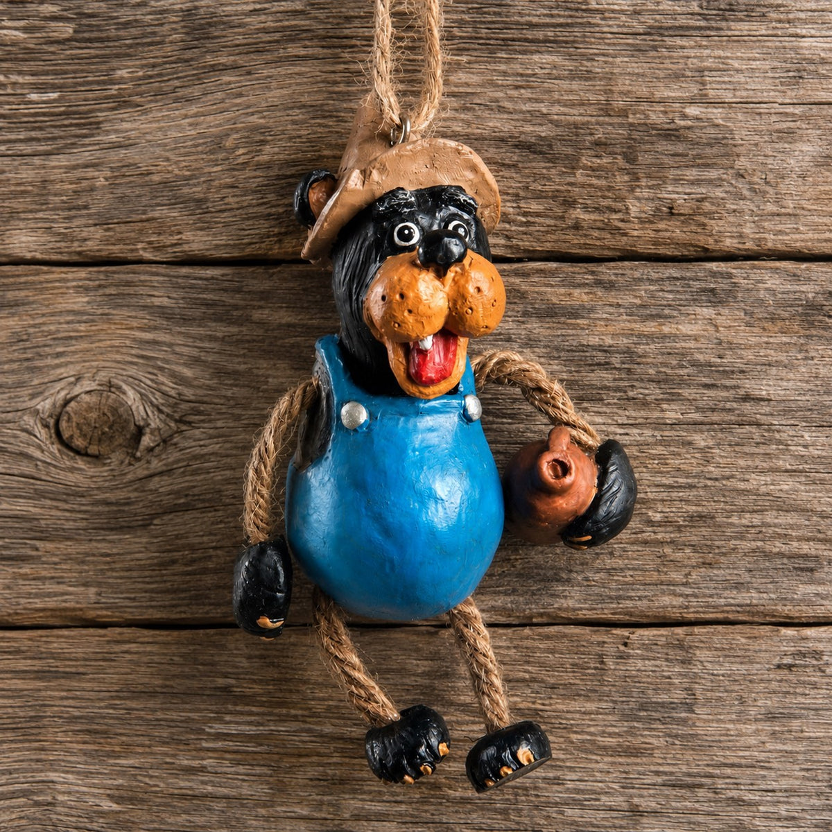 Bert Anderson  Moonshine Bear ornament hanging on rustic wood background.