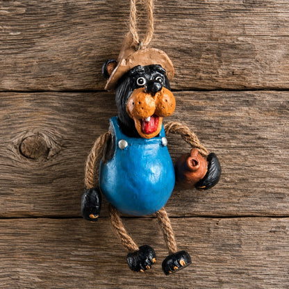 Bert Anderson  Moonshine Bear ornament hanging on rustic wood background.