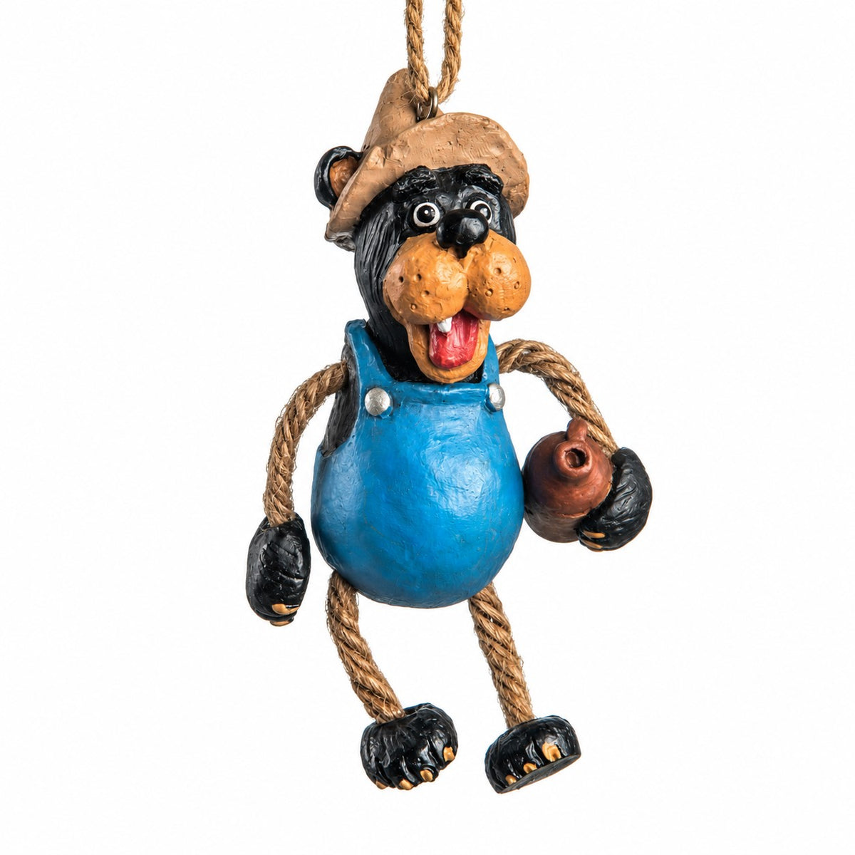 Bert Anderson Moonshine Bear ornament wearing blue overalls and a fishing hat, holding a brown jug with dangly rope arms and legs on a white background.