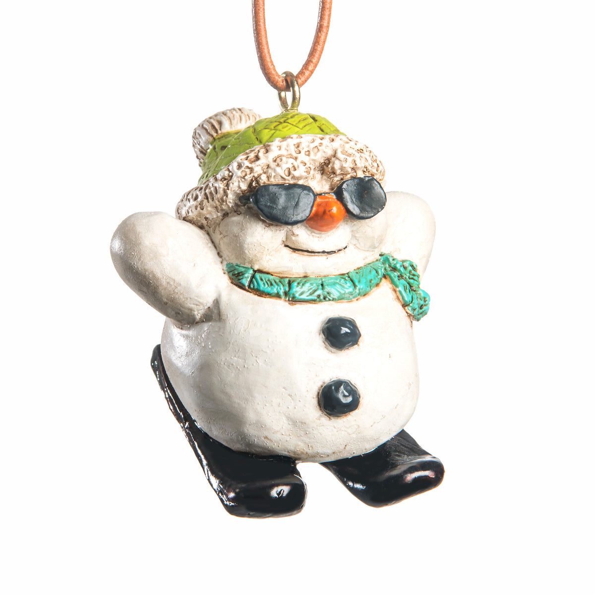 Skiing snowman ornament wearing a green hat, blue scarf and black sunglasses with black skis on a white background.