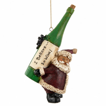 Bert Anderson Santa ornament carrying an oversized green wine bottle labeled “I Believe in Wine” on a white background.