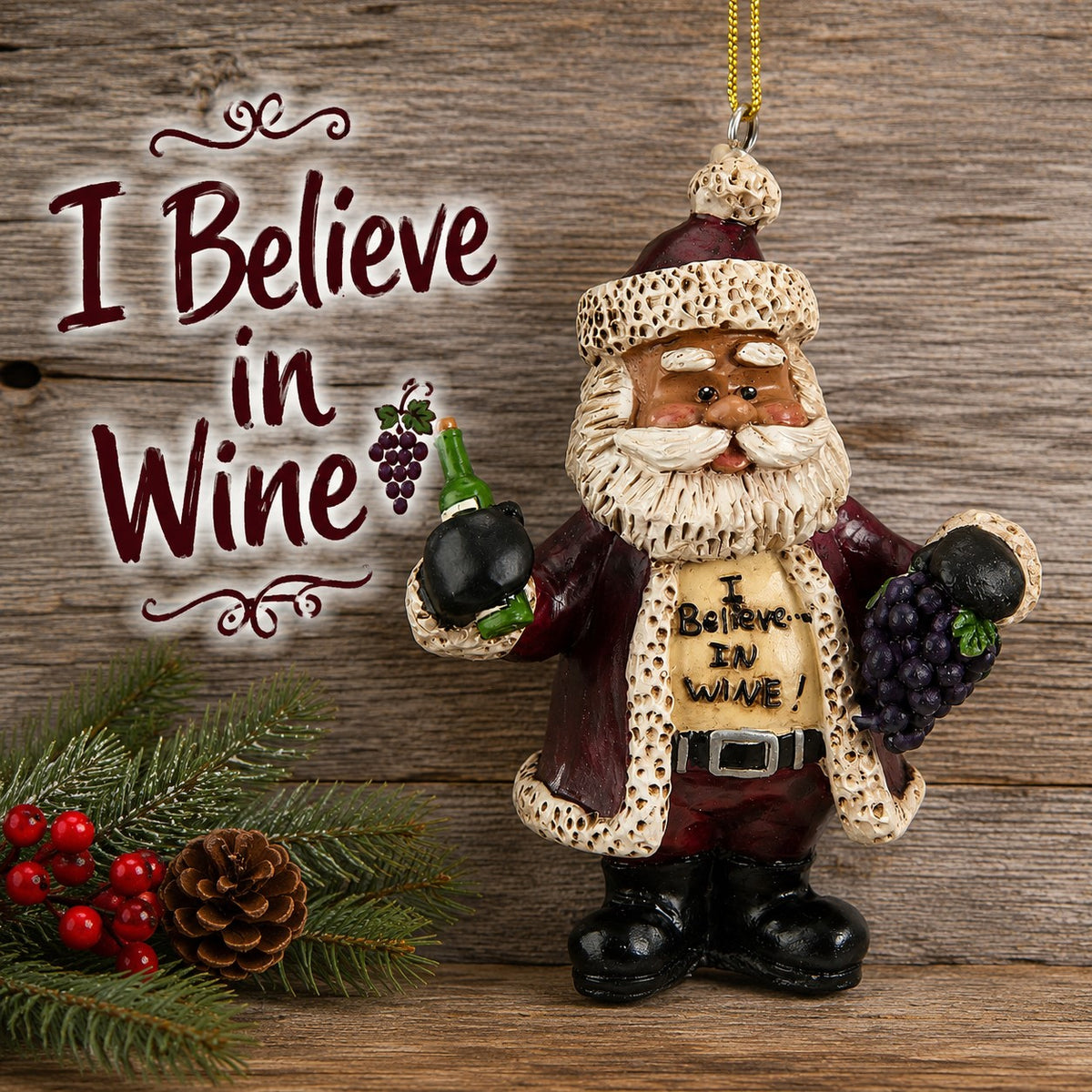 Bert Anderson “I Believe in Wine” Santa ornament holding a wine bottle and grapes against rustic wood with evergreen, berries and a pinecone.