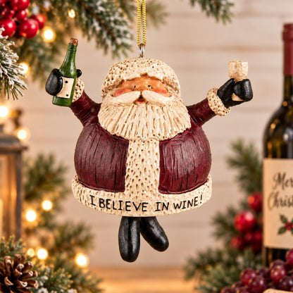 Bert Anderson Santa wine ornament holding a wine glass beside a wine barrel with grapes and “I Believe in Wine” displayed in a festive Christmas home décor setting.