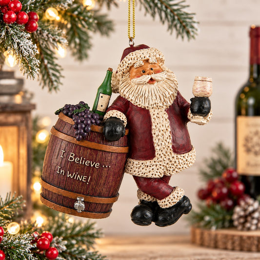Bert Anderson Santa wine ornament holding a wine glass beside a wine barrel with grapes and “I Believe in Wine” displayed in a festive Christmas home décor setting.